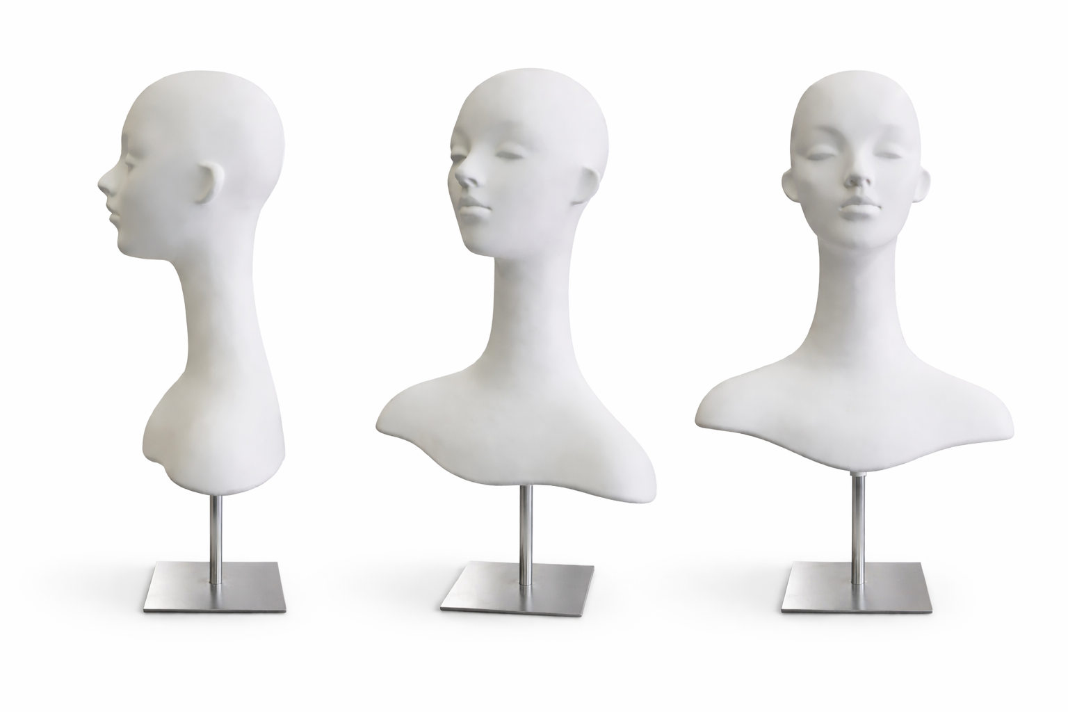 Three white mannequin heads on stands against a white background