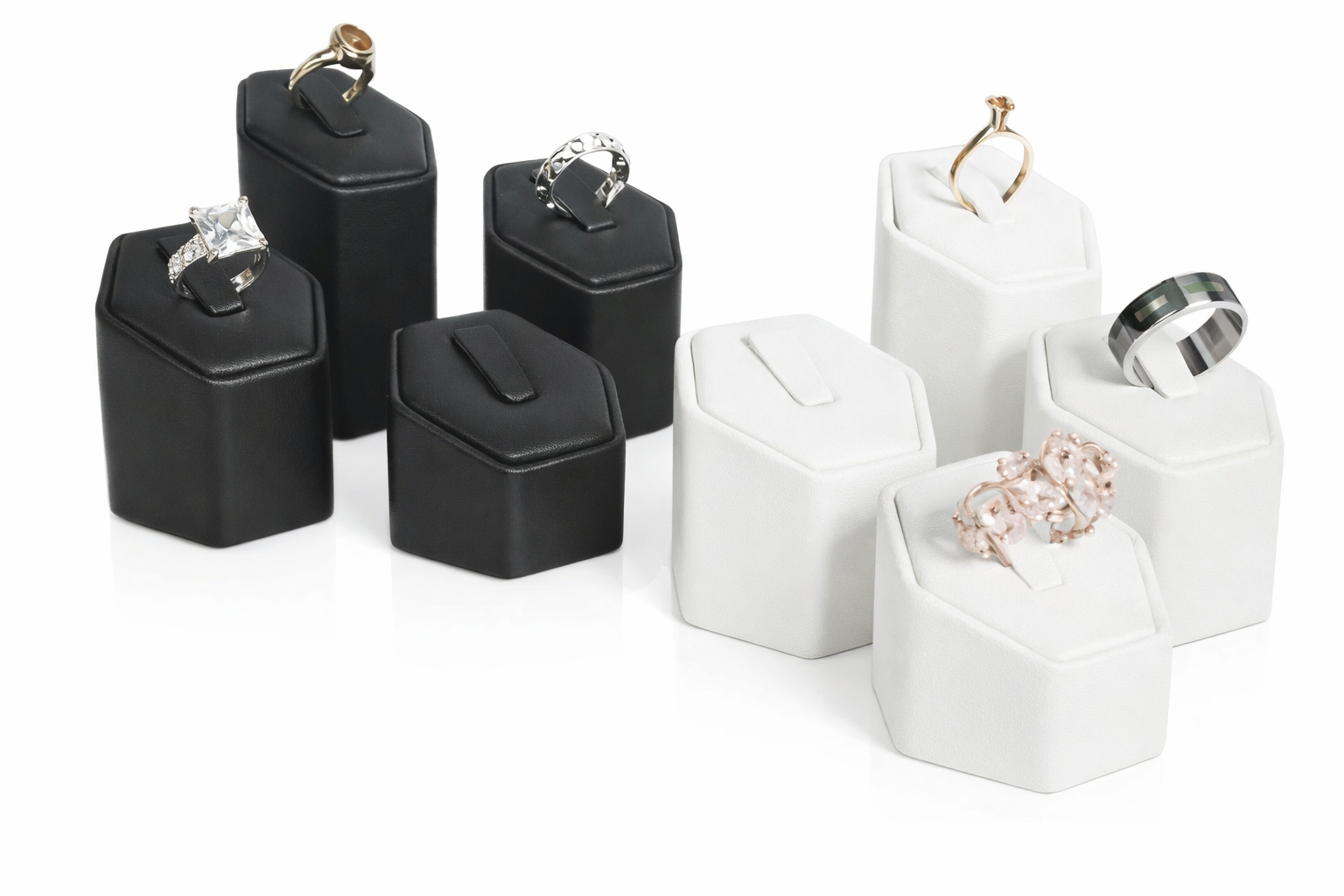 Black and white jewelry stands with rings on a white background