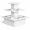 White three-tiered display stand with folded cloths on a white background