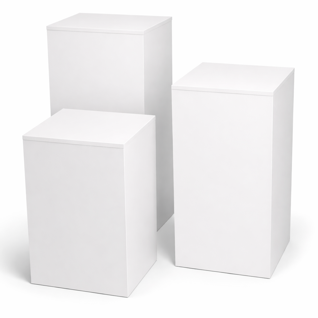 Three white cubes of different sizes on a white background