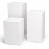 Three white cubes of different sizes on a white background
