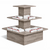 Wooden tiered display table with folded cloths on a white background