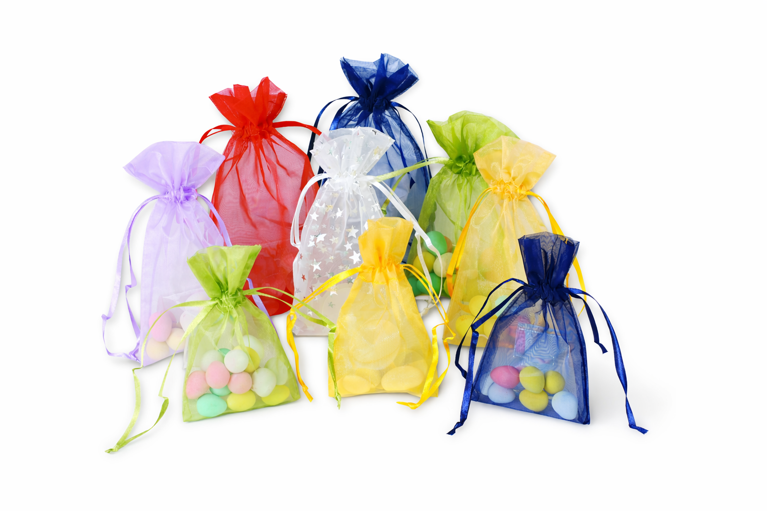 Colorful organza bags with candies on a white background